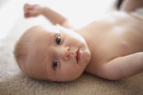 Caucasian baby laying on carpet