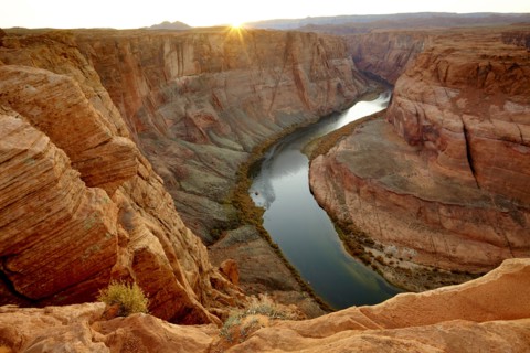 River winding through majestic rock formations in desert landscape
