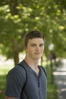 Caucasian student smiling on sidewalk