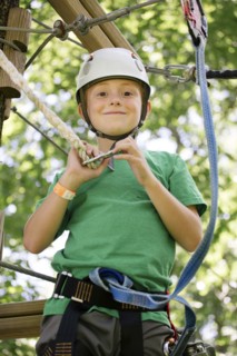 Caucasian boy hooking harness to line