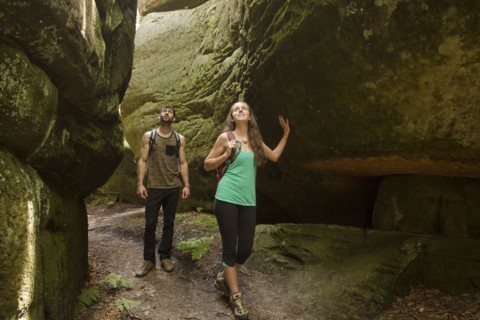 Caucasian couple exploring cave