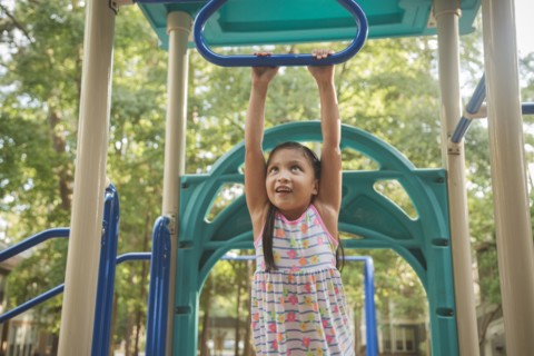 Hispanic playing on playground