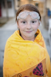 Portrait of Caucasian girl wrapped in towel after swimming