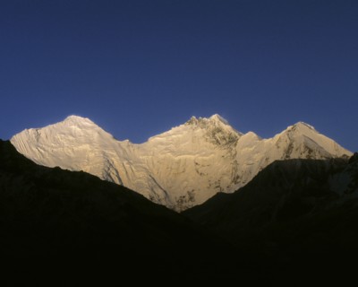 Snowy mountaintops under blue sky