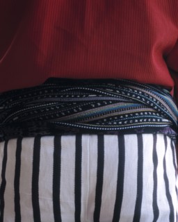 Close up of midsection of person wearing traditional clothing