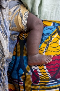 Close up of mother carrying baby with traditional wrap