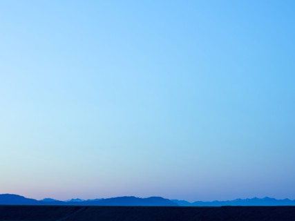 Silhouette of mountain range under blue sky