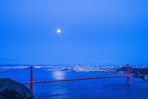 Moon in night sky over Golden Gate Bridge