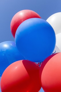 Low angle view of balloons under blue sky