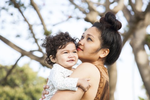 Mother holding baby son outdoors