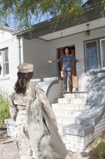 Black mother greeting soldier daughter