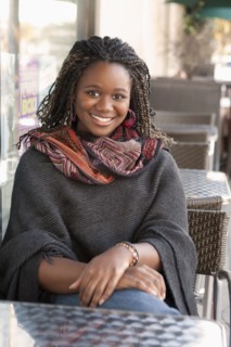 Black woman sitting at outdoor cafe