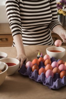 Woman dying Easter eggs