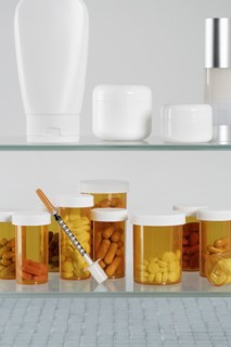 Medicine cabinet with  pill bottles and syringe