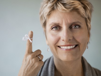 Caucasian woman with string tied on her finger