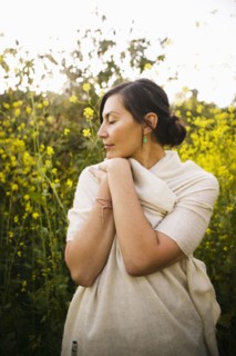 Mixed race woman with eyes closed in field