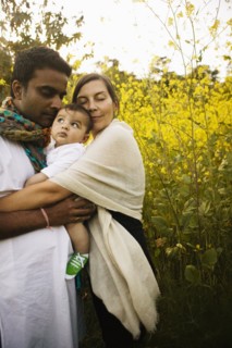 Family hugging in field