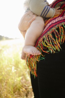 Mother holding baby in field