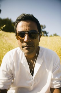 Serious mixed race man in field