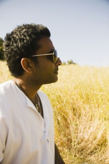 Serious mixed race man in field