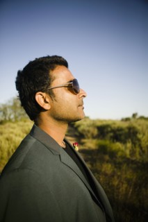 Serious mixed race man in field
