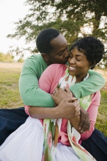 Black couple hugging in park