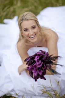 Hispanic bride holding bouquet of flowers