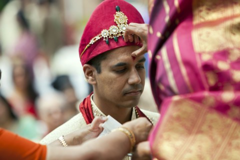 Indian woman marking groom's forehead