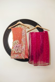 Colorful fabrics hanging by mirror