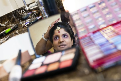 Indian bride having makeup done