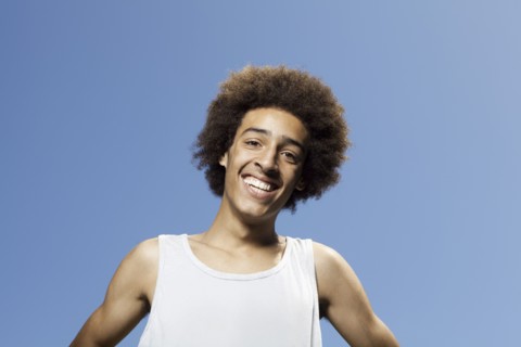 Smiling mixed race teenager standing outdoors