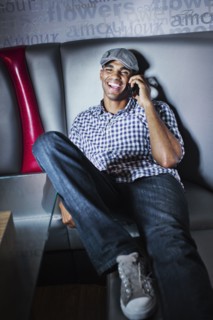 Man talking on cell phone in nightclub booth