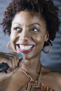 African American woman singing karaoke in nightclub