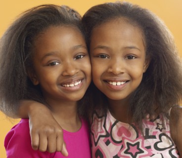 African sisters hugging