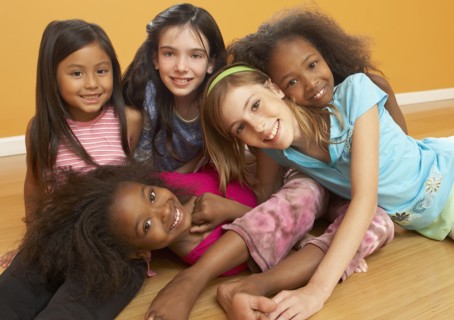 Children laying in pile and smiling