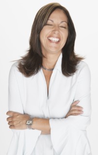 Portrait of Hispanic woman laughing with eyes closed