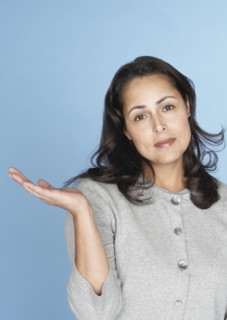 Skeptical Hispanic woman gesturing