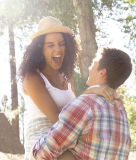 Couple playing in woods