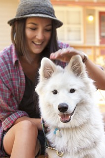 Woman petting dog outdoors