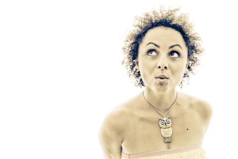 Portrait of curious woman wearing owl necklace