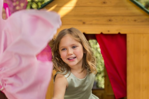 Smiling girl in playhouse