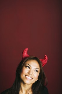 Asian woman wearing devil's horns