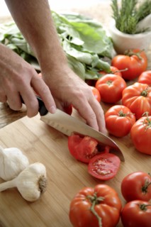 Caucasian man chopping tomatoes