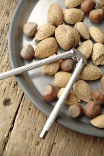 Variety of nuts and nutcracker on platter