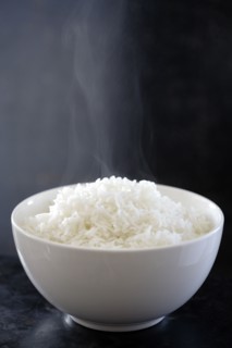 Steaming bowl of cooked rice