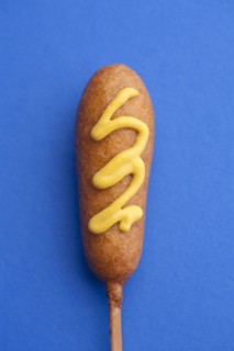 Close up of corn dog with mustard