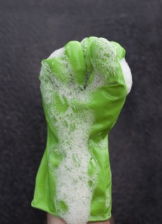 Close up of soap suds covering rubber glove