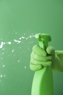 Green rubber glove squiring spray bottle