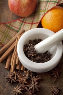 Fruit with spices in pestle and mortar