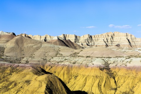 Layered rock formations under blue sky